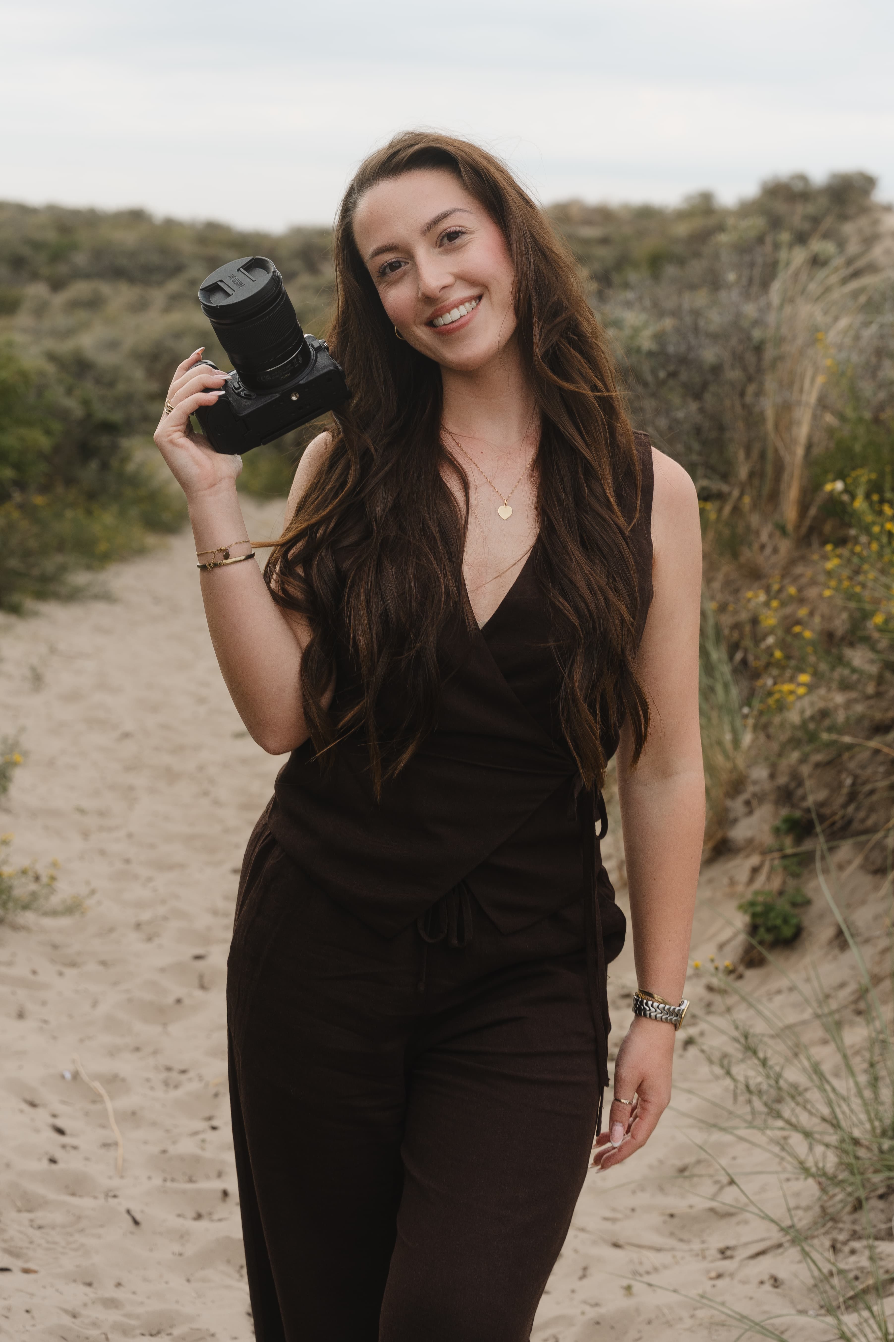Nina Regan met haar camera op een duinpad